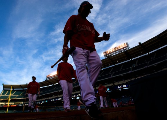 Erick Aybar of the Los Angeles Angels of Anaheim walks into the dugout after taking batting practice before Game 2 of the American League Division Series against the Boston Red Sox at Angel Stadium on October 9, 2009 in Anaheim, California. (Photo by Brad Mangin)