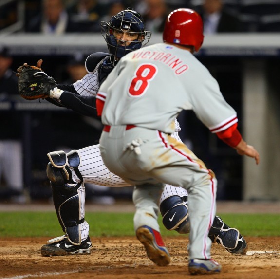 New York Yankees catcher Jorge Posada waits at home plate to tag out Philadelphia Phillies base runner Shane Victorino during Game 1 o the World Series at Yankee Stadium in New York. (Photo by Brad Mangin/MLB Photos)