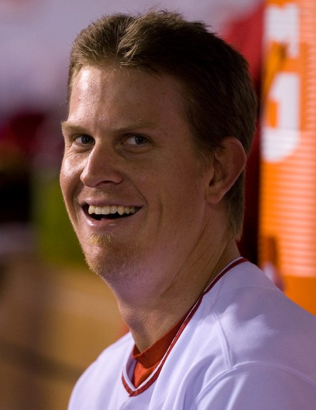 Jered Weaver of the Los Angeles Angels of Anaheim smiles and sits in the dugout against the Boston Red Sox during Game 2 of the American League Division Series at Angel Stadium on October 9, 2009 in Anaheim, California. (Photo by Brad Mangin)