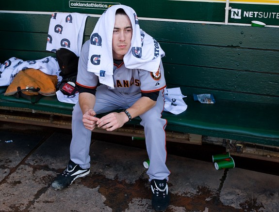 Tim Lincecum #55 of the San Francisco Giants gets ready in the dugout before the game against the Oakland Athletics at the Oakland-Alameda County Coliseum on June 23, 2009 in Oakland, California. (Photo by Brad Mangin)