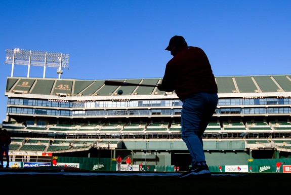 Manager Mike Scioscia of the Los Angeles Angels of Anaheim hits fungoes before the game against the Oakland Athletics at the McAfee Coliseum in Oakland, California on September 17, 2008. (Photo by Brad Mangin)