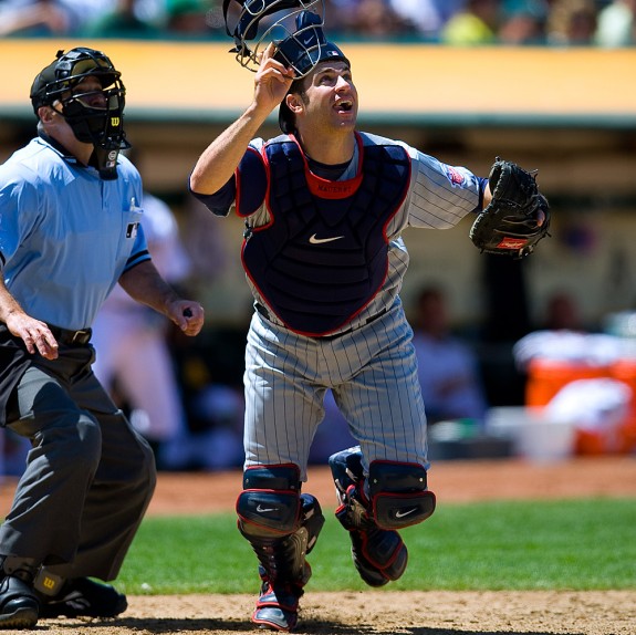 Joe Mauer of the Minnesota Twins chases a foul ball during the game against the Oakland Athletics at the Oakland Coliseum in Oakland, California on Thursday, June 11, 2009. (Photo by Brad Mangin)