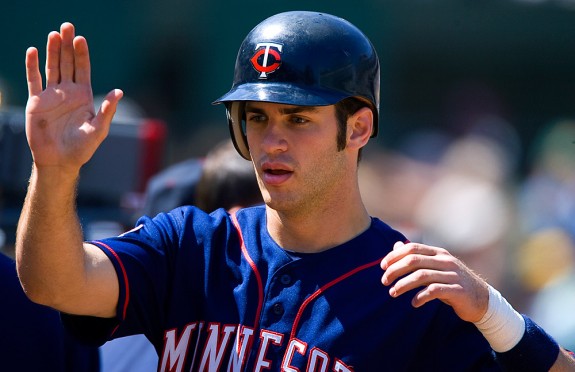 Joe Mauer #7 of the Minnesota Twins celebrates with his teammates during a game against the Oakland Athletics at the Oakland-Alameda County Coliseum on August 14, 2005. (Photo by Brad Mangin) 