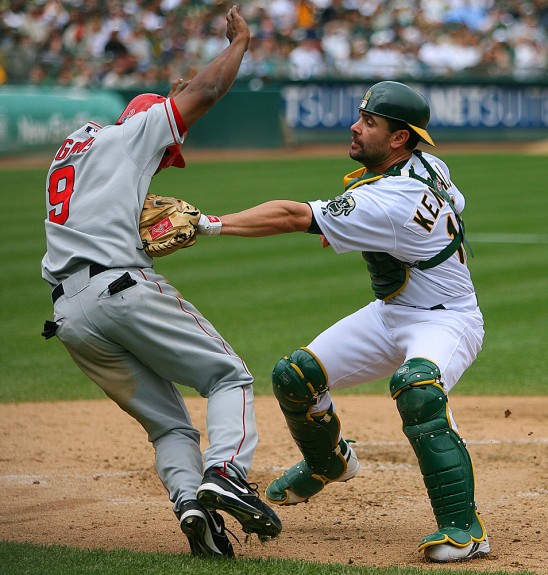 Oakland Athletics catcher Jason Kendall tags out Los Angeles Angels of Anaheim base runner Chone Figginsduring their game at McAfee Coliseum in Oakland, CA on April 22, 2006. (Photo by Brad Mangin)