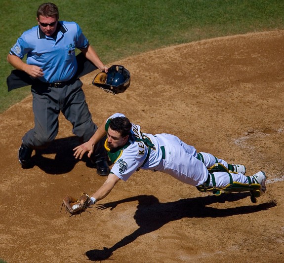 Oakland Athletics catcher Jason Kendall makes a diving catch during a game against the Chicago White Sox at McAfee Coliseum in Oakland, CA on September 16, 2006. (Photo by Brad Mangin)