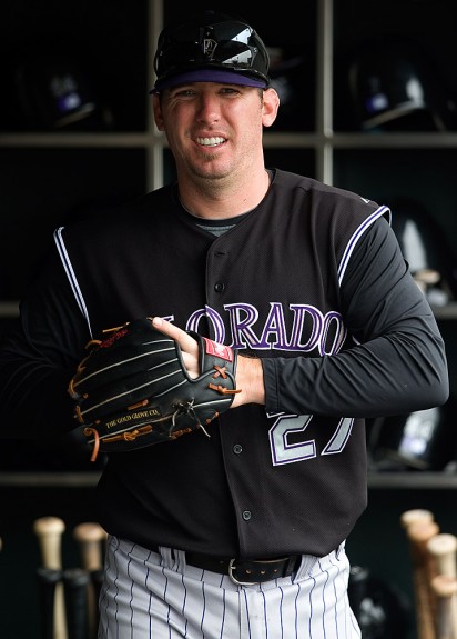 Garrett Atkins #27 of the Colorado Rockies gets ready in the dugout before the game against the San Francisco Giants at AT&T Park on May 3, 2009 in San Francisco, California. (Photo by Brad Mangin)