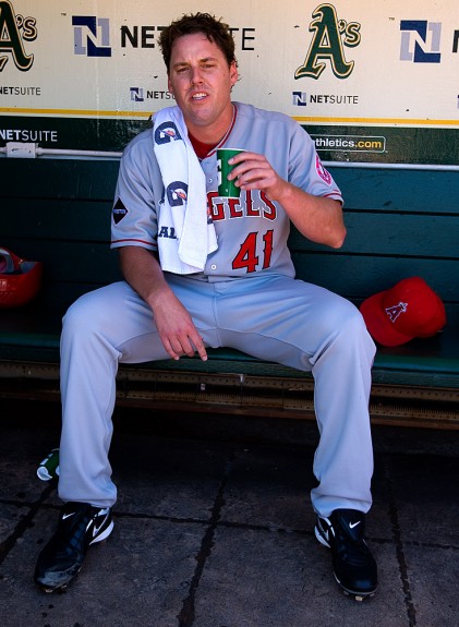 John Lackey of the Los Angeles Angels of Anaheim gets ready in the dugout and yells at photographer Brad Mangin before the game against the Oakland Athletics at the Oakland-Alameda County Coliseum on July 19, 2009 in Oakland, California. (Photo by Brad Mangin)