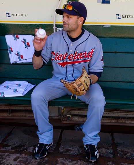 Jamey Carroll of the Cleveland Indians gets ready in the dugout before the game against the Oakland Athletics at the Oakland-Alameda County Coliseum on September 19, 2009 in Oakland, California. (Photo by Brad Mangin)