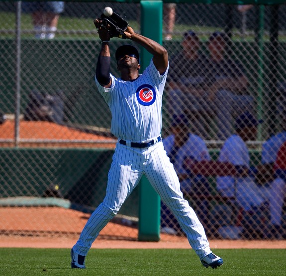 Milton Bradley of the Chicago Cubs catches a fly ball in right field during their spring training game against the Milwaukee Brewers at HoHoKam Park in Mesa, Arizona on February 26, 2009. (Photo by Brad Mangin)