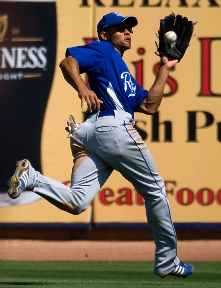 Coco Crisp of the Kansas City Royals catches a fly ball during a spring training game against the San Diego Padres at the Peoria Sports Complex in Peoria, Arizona on March 23, 2009. (Photo by Brad Mangin)