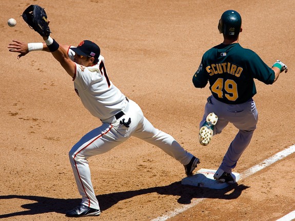 Oakland Athletics base runner Marco Scutaro beats out an infield hit as San Francisco Giants first baseman Pedro Feliz takes the late throw during their game at AT&T Park in San Francisco, CA on July 4, 2004. (Photo by Brad Mangin)