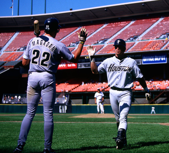 SAN FRANCISCO, CA - Jeff Bagwell of the Houston Astros in action getting congratulated on his way back to the dugout by teammate Dave Magadan during a game against the San Francisco Giants at Candlestick Park in San Francisco, California in 1995. Photo by Brad Mangin
